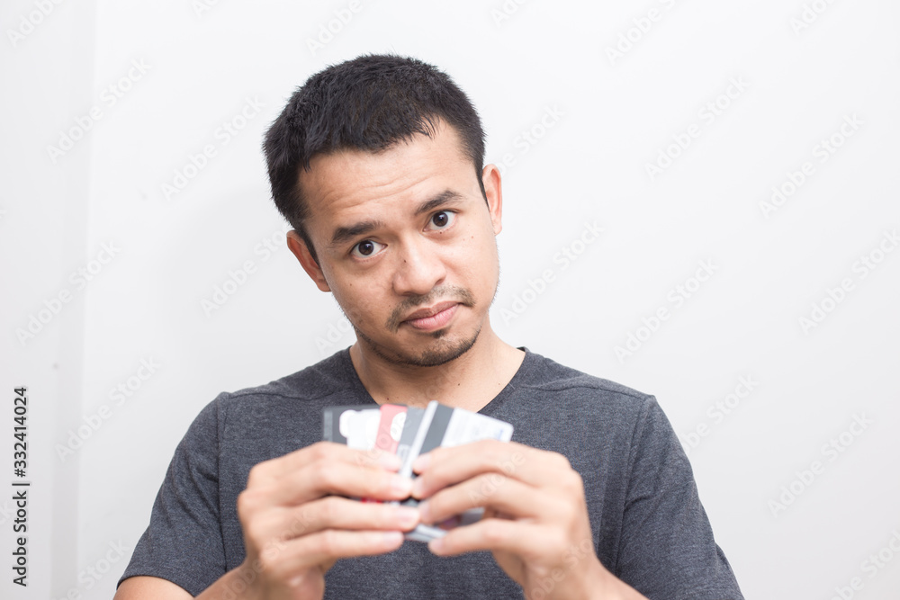 Business handsome man in grey shirt holding with many credit card Business handsome man in grey shirt holding with many credit card