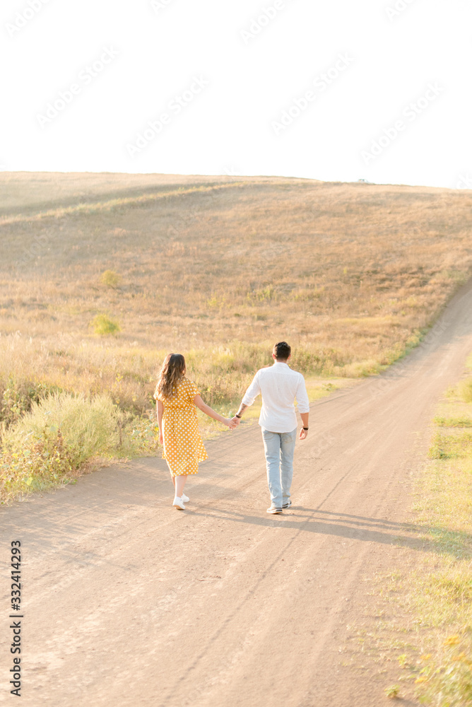 young couple walking on a field