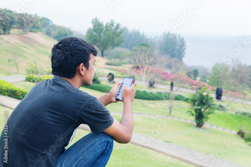A man using a telephone in a park