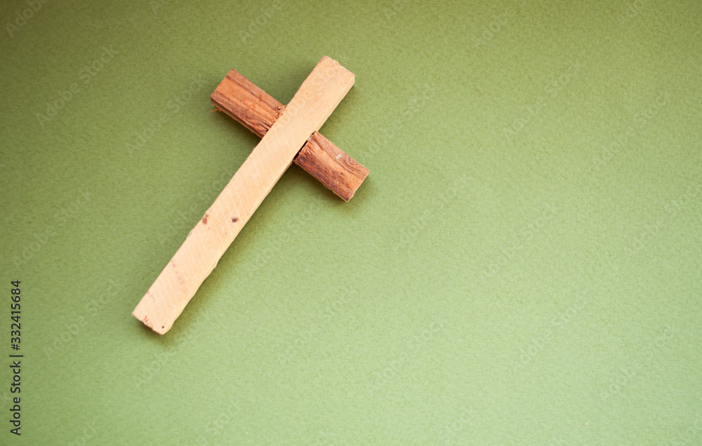 Wooden cross on a green background, easter day, world prayer day, international prayer day Wooden cross on a green background, easter day, world prayer day, international prayer day