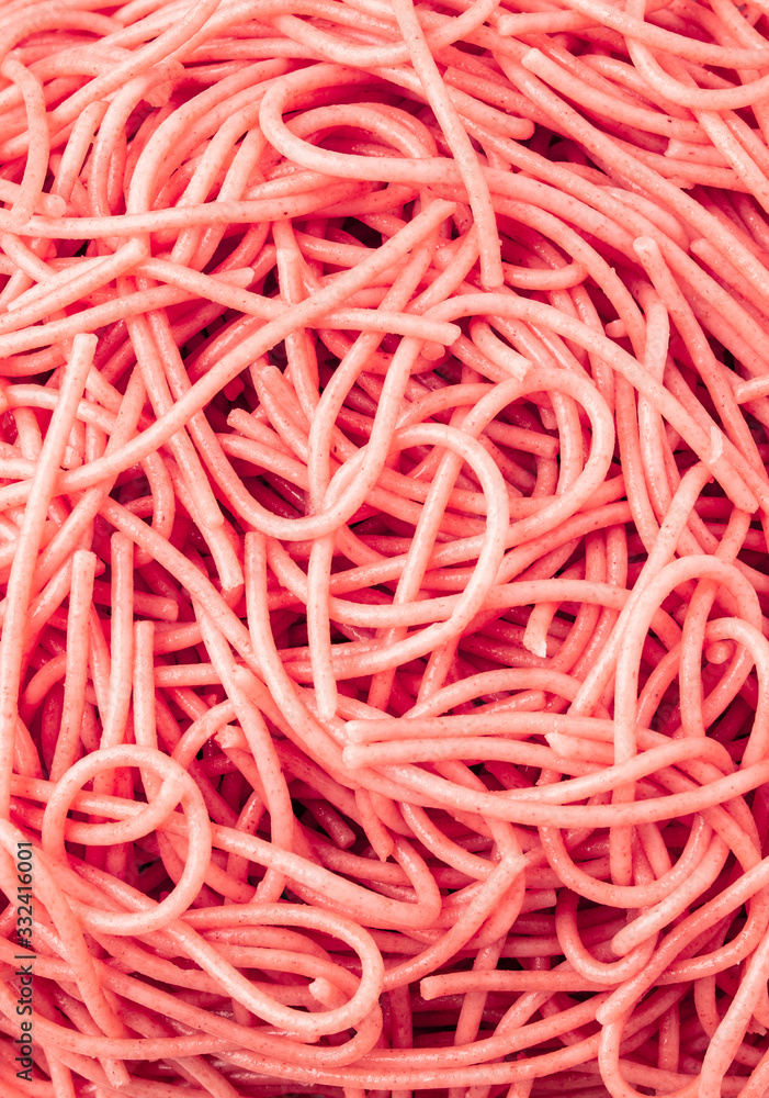Pink gluten-free wholemeal spaghetti textured background seen from above. Gluten-free healthy food concept