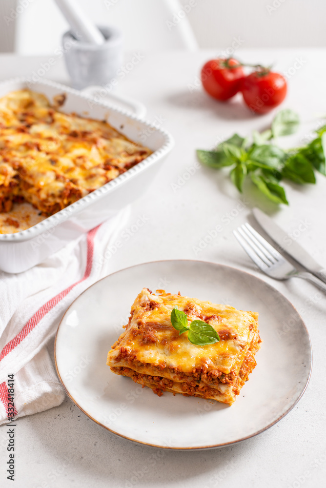 Delicious Homemade Italian Lasagna with bolognese and bachamel Sauce on white Background. Hot Tasty Lasagna with Parmesan Cheese. Restaurant menu, recipe