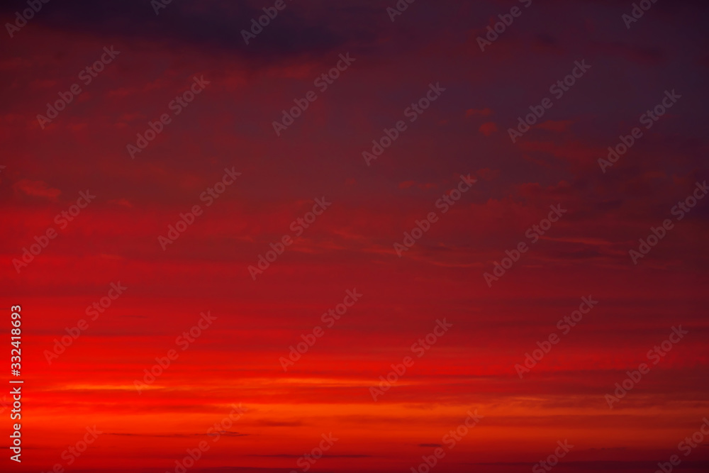 Beautiful Twilight sky background. Colorful Fiery orange and red sunset sky.