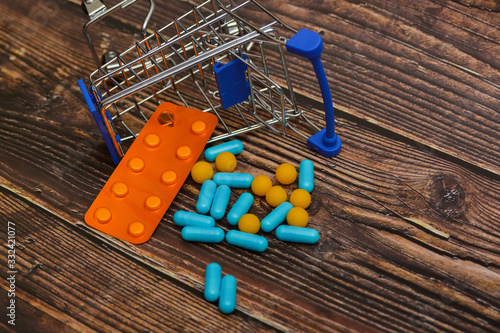 Inverted trolley and pills and medicines lie nearby, the concept of the uselessness and futility of treatment.