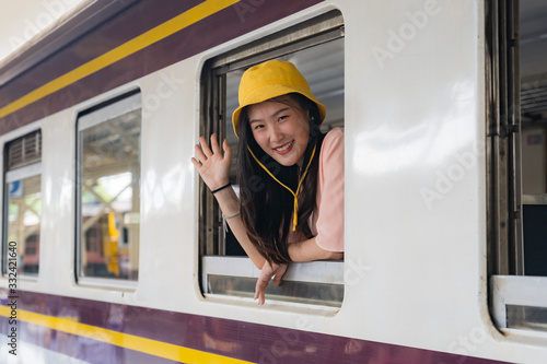 Happy beautiful woman sitting in the train