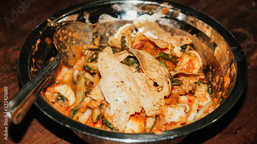 Close-up of Pecel - Traditional Javanese salad, consisting of mixed vegetables in a peanut sauce dressing, served with omelet.