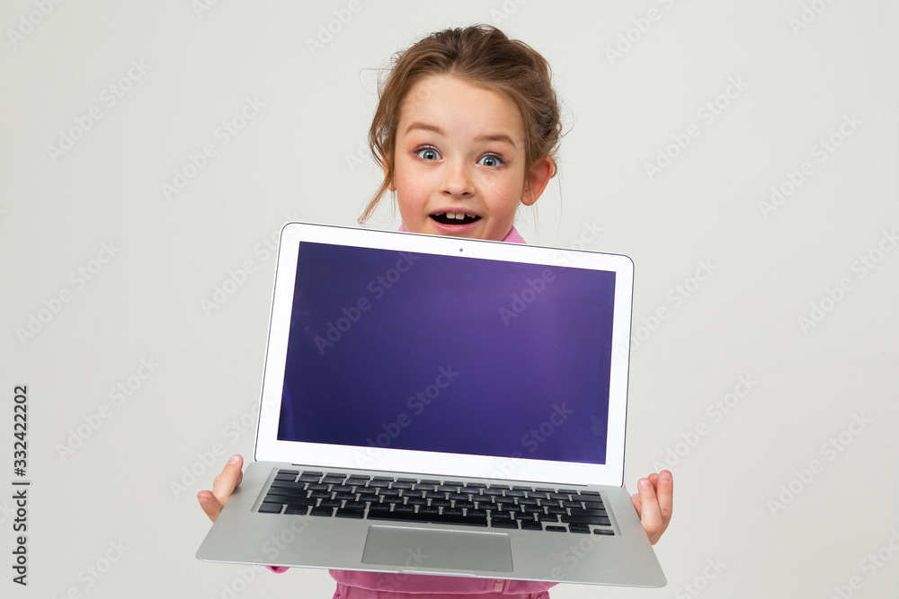 contented caucasian girl holding a laptop with the screen forward with the layout for the page on a white background contented caucasian girl holding a laptop with the screen forward with the layout for the page on a white background