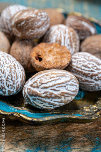 Dried nutmegs nuts in vintage bowl