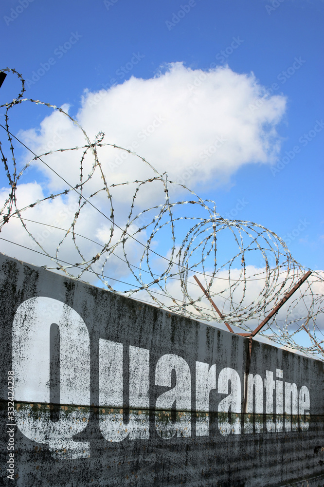 Image of wall and barbwire with text quarantine added by computer in post production. Concept of closing borders because virus covid-19. Image of wall and barbwire with text quarantine added by computer in post production. Concept of closing borders because virus covid-19.