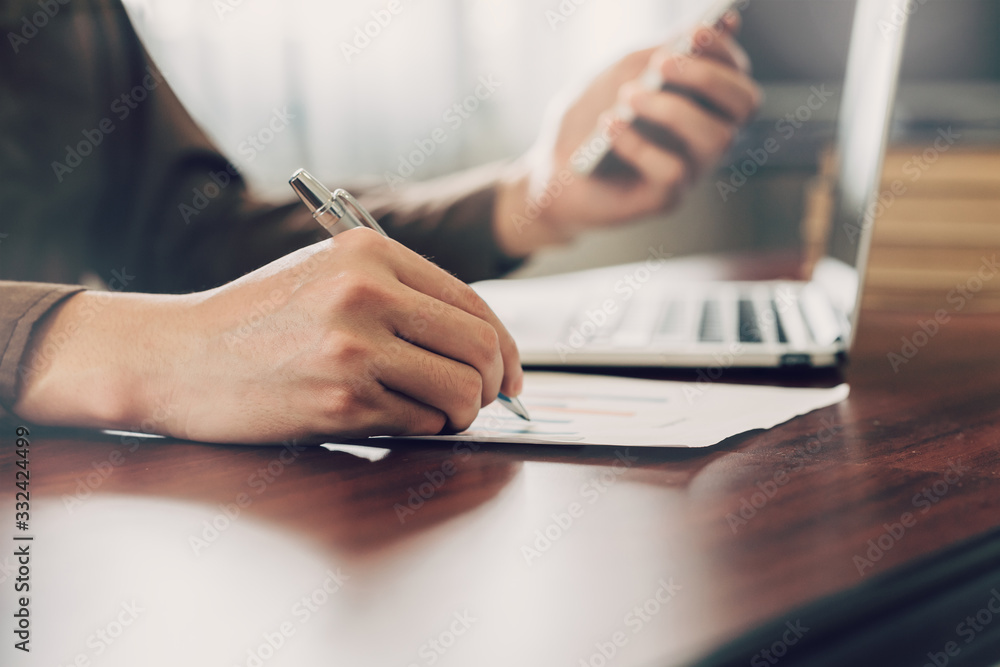 business man hand writing note paper on wooden table