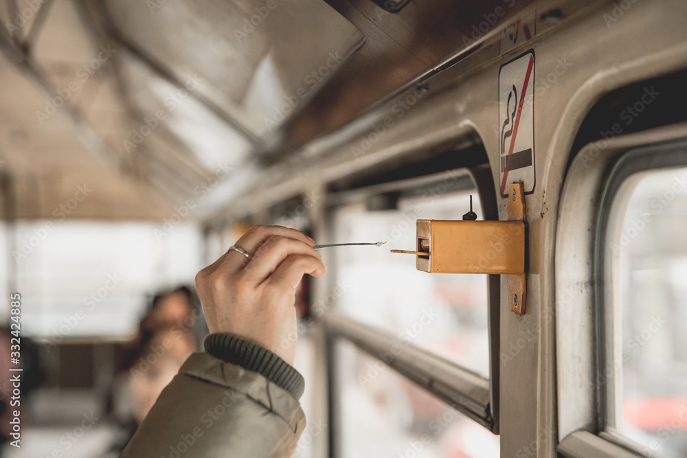 marking the ticket in the tram using a perforator