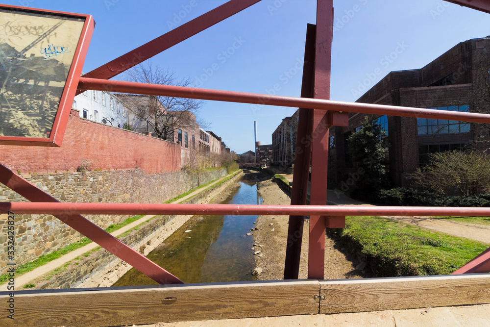 Creative view looking eastwards along the Chesapeake & Ohio Canal from a public footbridge in Georgetown, Washington DC Creative view looking eastwards along the Chesapeake & Ohio Canal from a public footbridge in Georgetown, Washington DC
