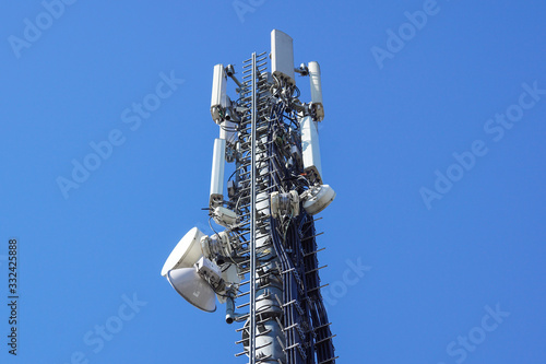 Принти на полотні Close up white color antenna repeater tower on blue sky