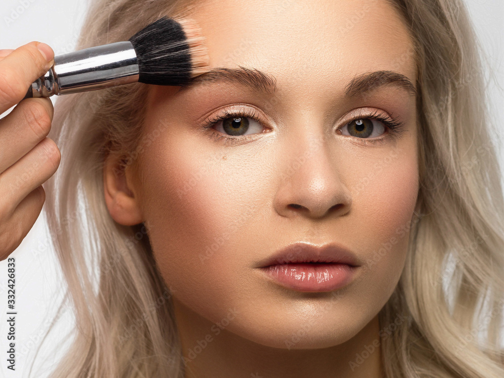 Closeup portrait of a woman with developing straight hair. Sweet tender young girl blonde. Natural lipstick, transparent clean skin. Skin care natural cosmetics in the spa salon or cosmetology. Closeup portrait of a woman with developing straight hair. Sweet tender young girl blonde. Natural lipstick, transparent clean skin. Skin care natural cosmetics in the spa salon or cosmetology.