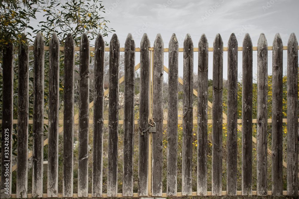 Fototapeta premium Gate closed and locked with padlock. Dramatic picture concept world closed. world lock down