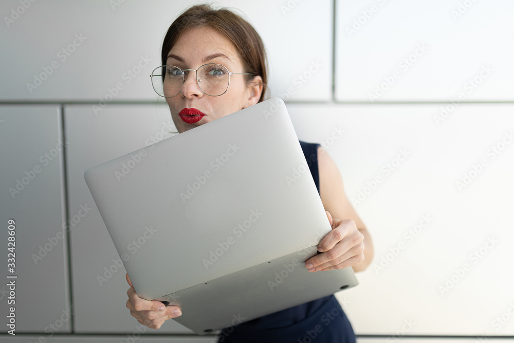 Female in office suit made an appointment and stands with laptop outside Female in office suit made an appointment and stands with laptop outside