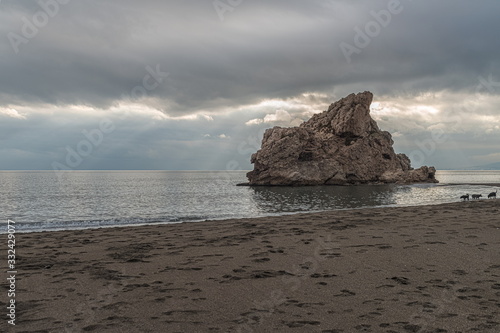 Sunset with sky clouds in the famous "Peñon del Cuervo" beach in Malaga. Costa del Sol. Spain.