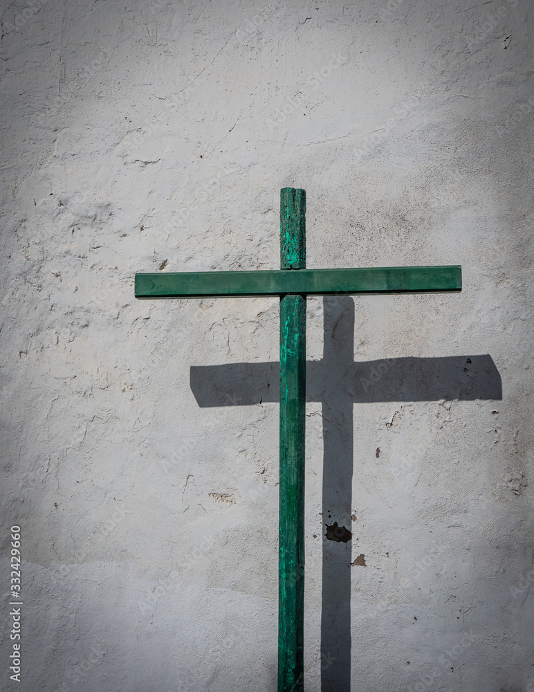 The old wooden cross against a wall in city Teguise, Lanzarote