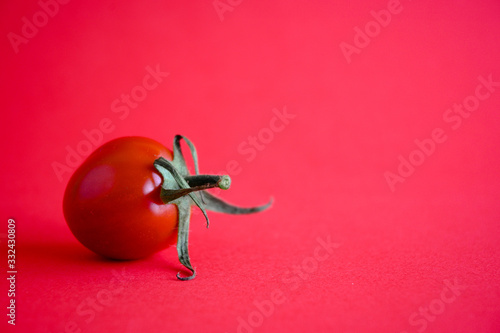 Cherry tomato on a red background