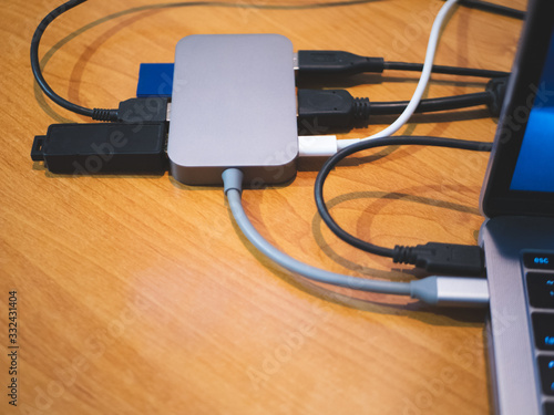 usb type-c hub connected to laptop with lot of cables connected for peripheral computer device equipment photo