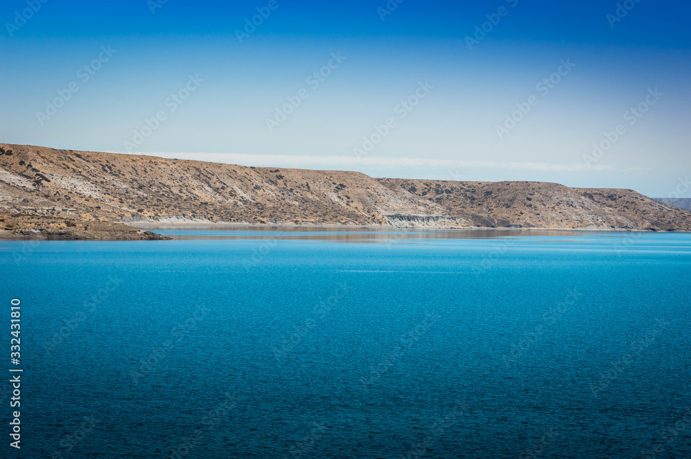 Turquoise lake and mountains in the background. I walk along the Neuquén highway, Argentina.