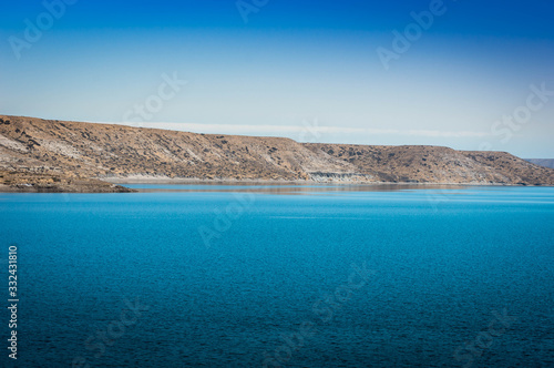 Turquoise lake and mountains in the background. I walk along the Neuquén highway, Argentina.