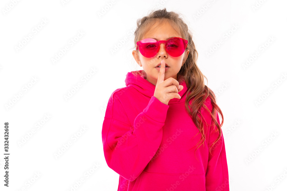 girl in a pink sweater shows the sound of silence on a white background with copy space girl in a pink sweater shows the sound of silence on a white background with copy space