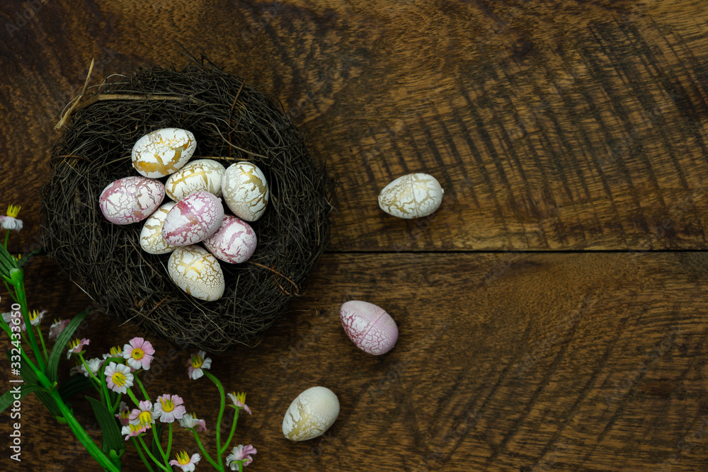 Top view shot of arrangement decoration Happy Easter holiday background concept.Flat lay colorful bunny eggs with flower accessory ornament on modern rustic wooden at office desk.space for design.