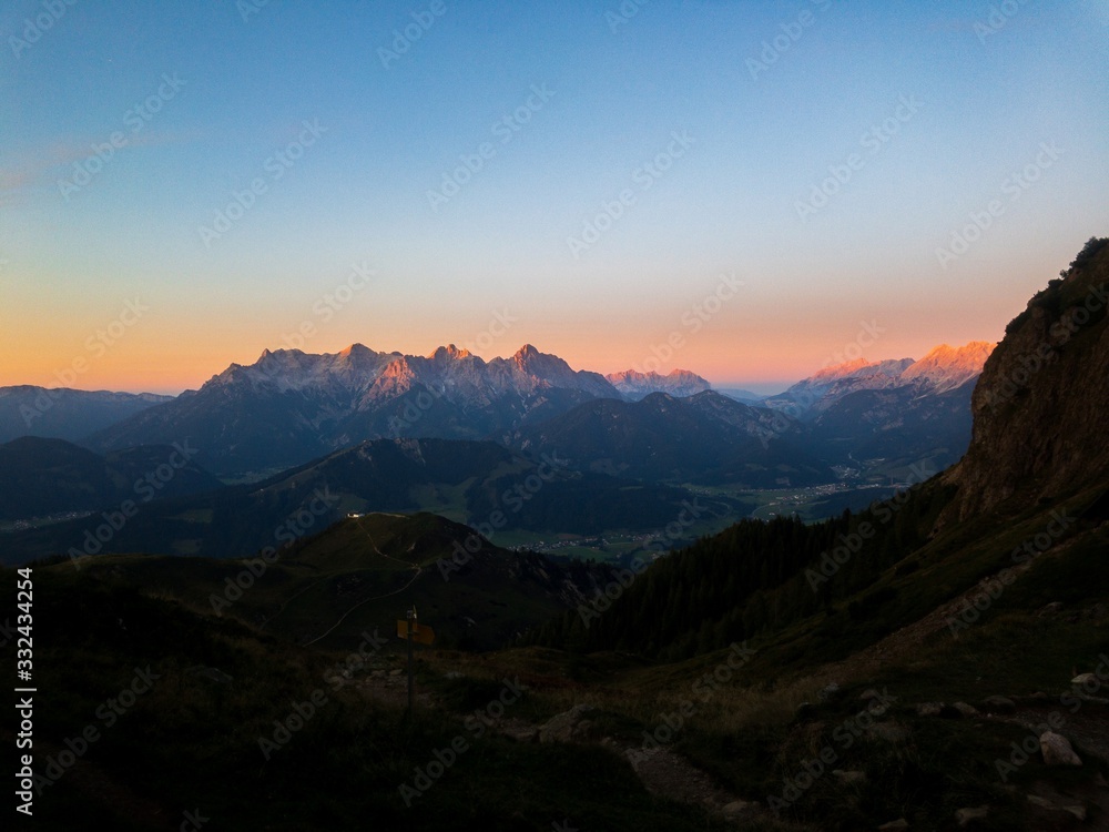 Sunset in the Austrian Alps; orange sun
