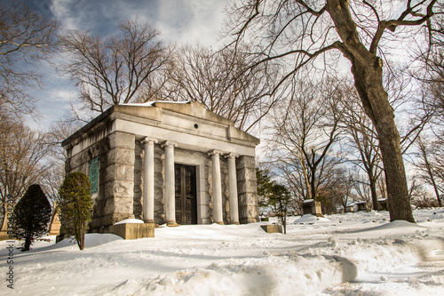 A wide-angle shot of a stately mausoleum in a winter landscape