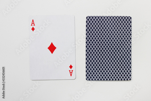 Ace of diamonds playing card with deck isolated on empty white table background. Poker, blackjack and various indoor card game accessory, ace of tiles single card photo