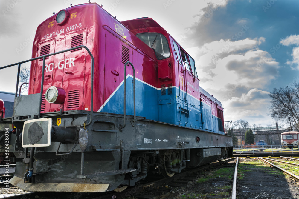 Red blue diesel locomotive stationary on railway. Red blue diesel locomotive stationary on railway.