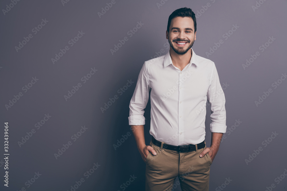 Photo of young macho business man employer investor corporate seminar friendly smiling hands in pockets wear white office shirt trousers isolated grey color background