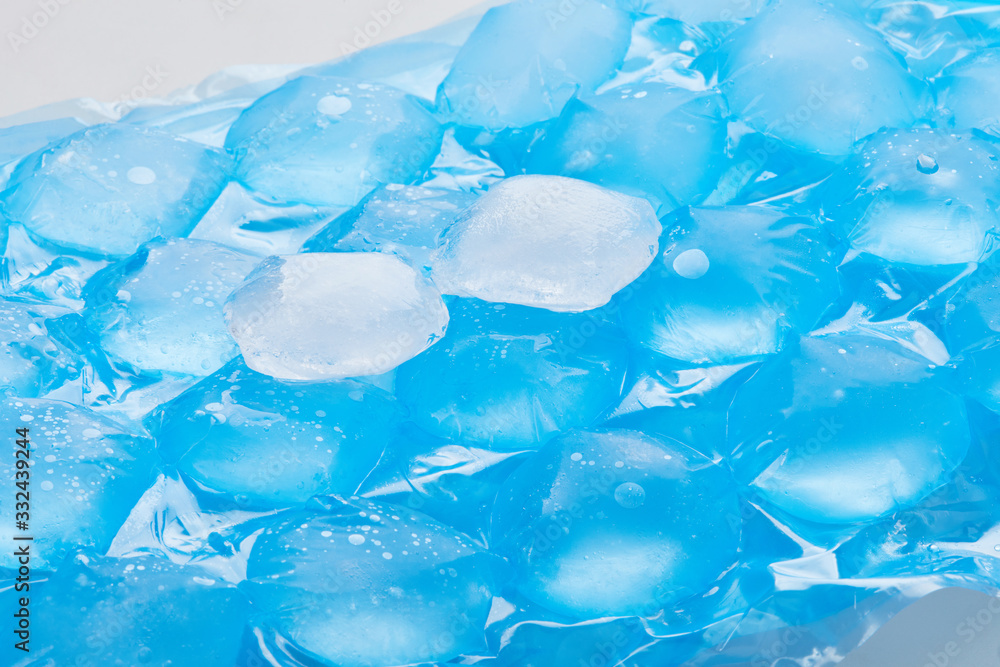 Blue plastic packaging ice bags for home water freezing. Ice cubes in plastic bags, freezer for ice circle cubes Blue plastic packaging ice bags for home water freezing. Ice cubes in plastic bags, freezer for ice circle cubes