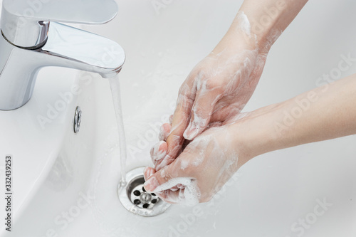 Washing hands with antibacterial soap in hot water to protect against spread of coronavirus germs.Hygiene and safety in infectious diseases.