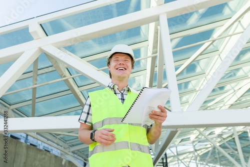 Portrait of young male builder at construction site Free Download Portrait of young male builder at construction site - GFXLoad