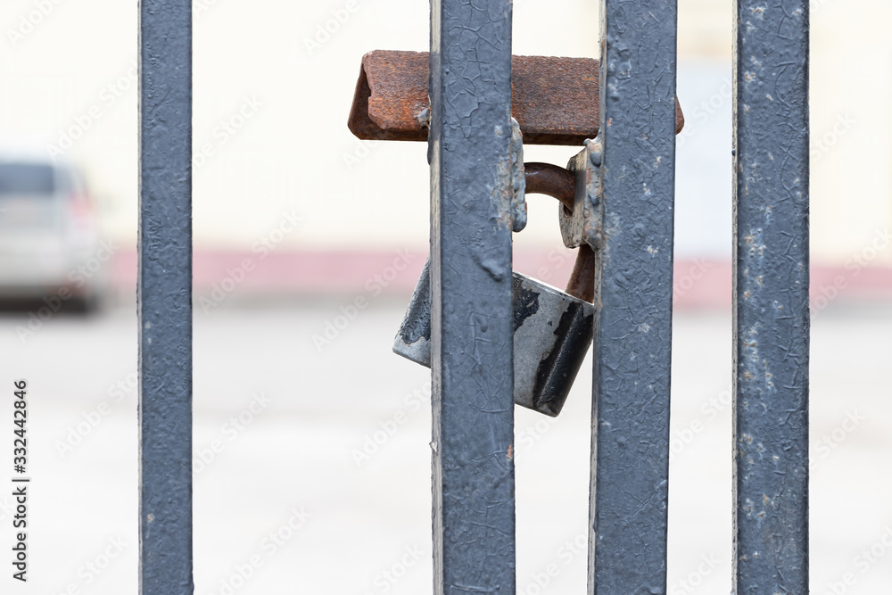 Closed and locked door grill with silver padlock. Closed and locked door grill with silver padlock.