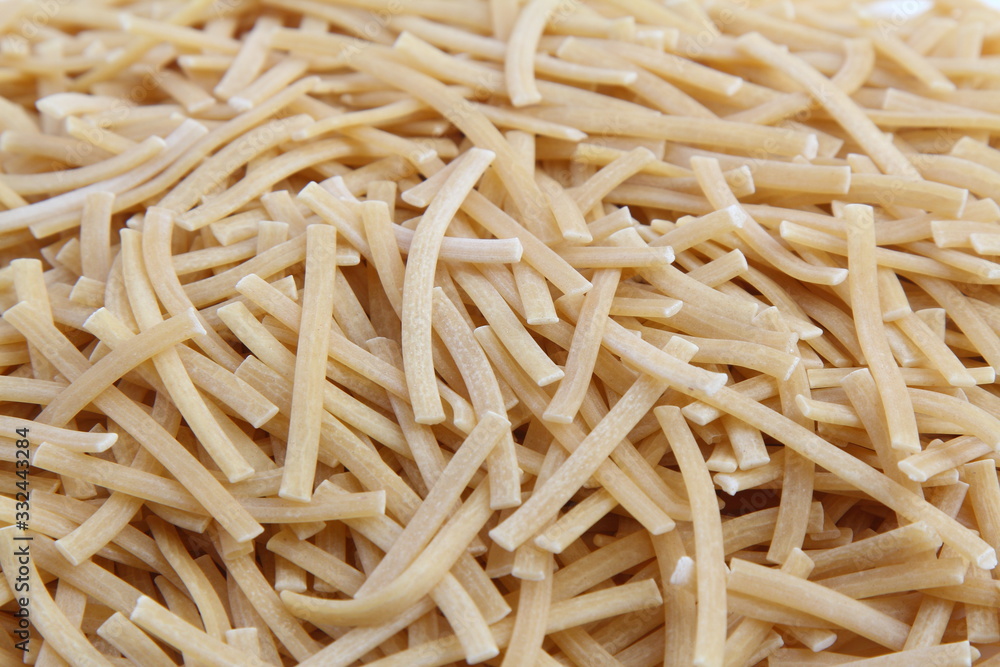 Dry uncooked vermicelli as a background texture. Close-up, top view Dry uncooked vermicelli as a background texture. Close-up, top view