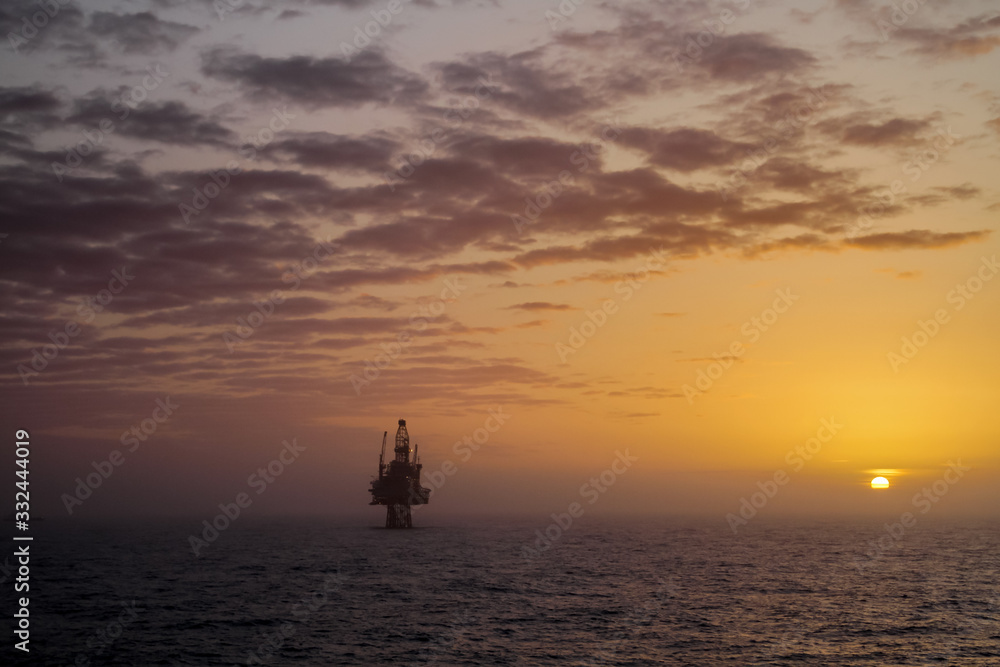 Oil platform at sunset in the North Sea. Oil platform at sunset in the North Sea.