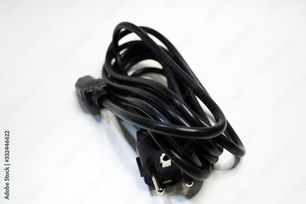 Black wire twisted into a small ball isolated on white background. Electronic plug european model with ground 220 voltage for PC. Black wire twisted into a small ball isolated on white background. Electronic plug european model with ground 220 voltage for PC.