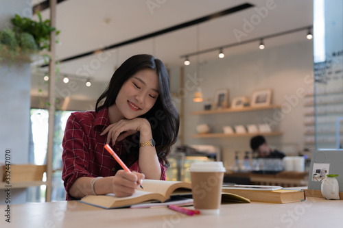 Close up of young business woman big smiling from ear to ear while holding tablet in her hand at table, successful concept