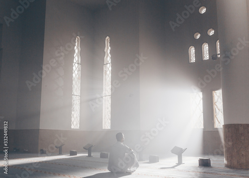 Young Muslim Guy Reading The Koran