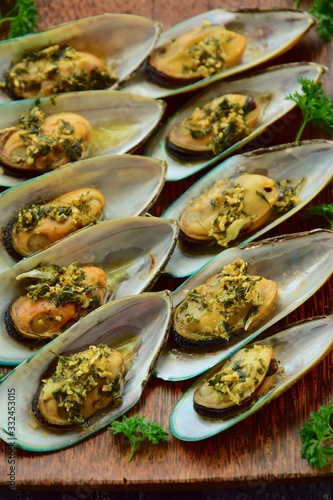 Baked green mussels with garlic butter herb sauce 