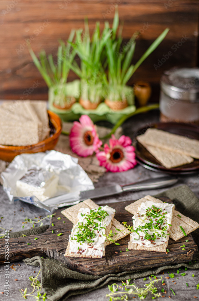 Delicious fresh cheese with herbs on crispbread Delicious fresh cheese with herbs on crispbread