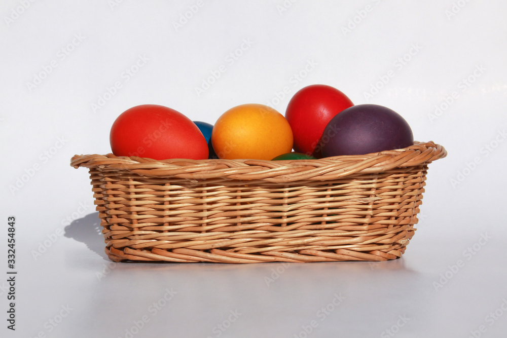 Easter eggs colors in basket white background Easter eggs colors in basket white background