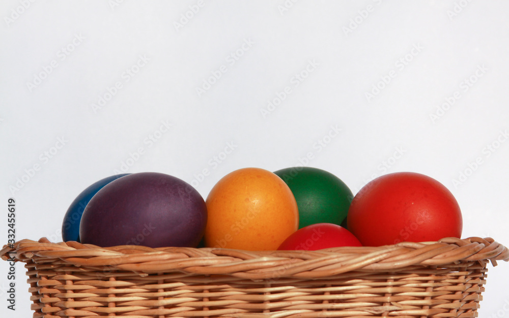 Easter eggs colors in basket white background Easter eggs colors in basket white background