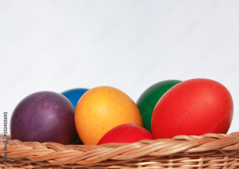 Easter eggs colors in basket white background Easter eggs colors in basket white background
