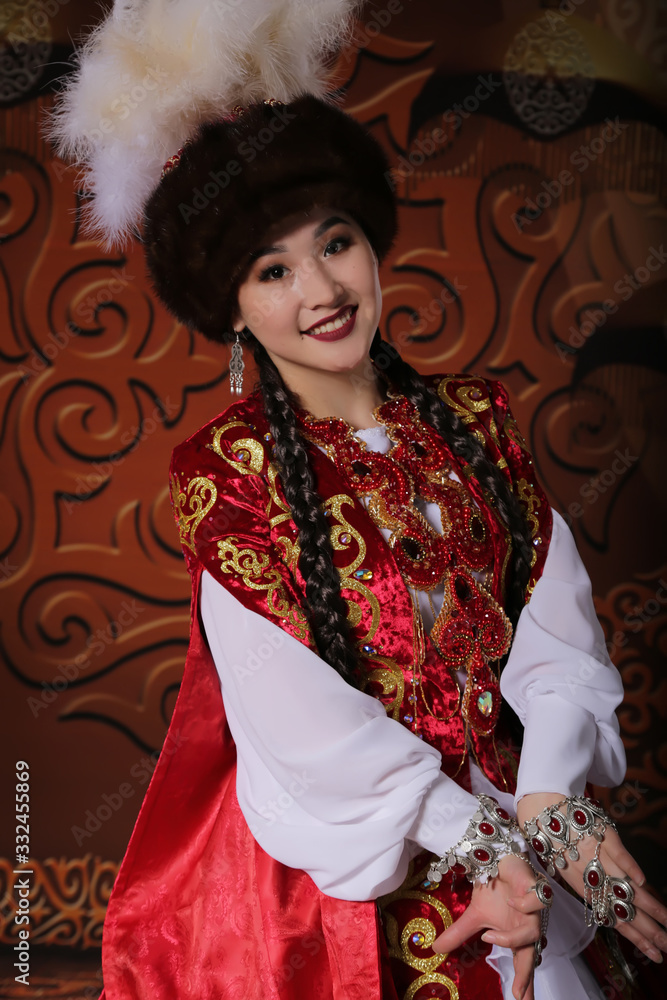 Obraz premium Kazakh national wedding dress. Ornaments and embroidery on fabric. Red dress. Traditional dress of the Kazakh bride.
