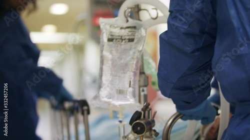 Doctors and nurses rush a critically wounded patient on a stretcher