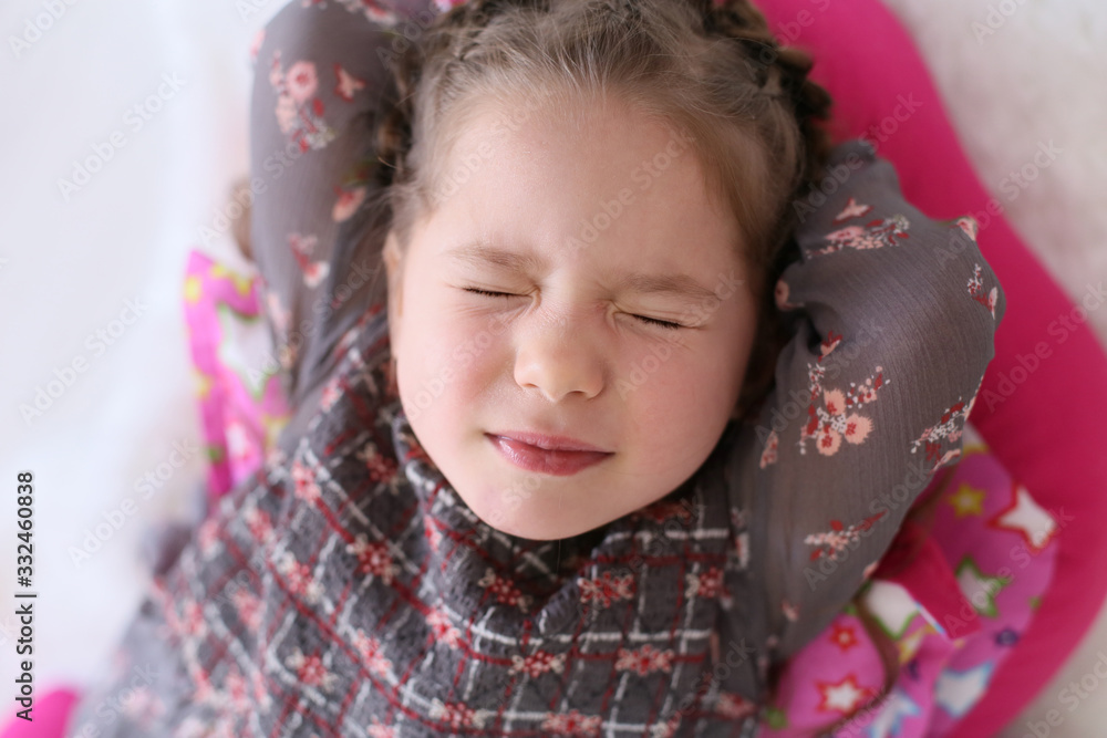 horizontal closeup portrait of a four year old girl lying on the floor with her eyes closed horizontal closeup portrait of a four year old girl lying on the floor with her eyes closed